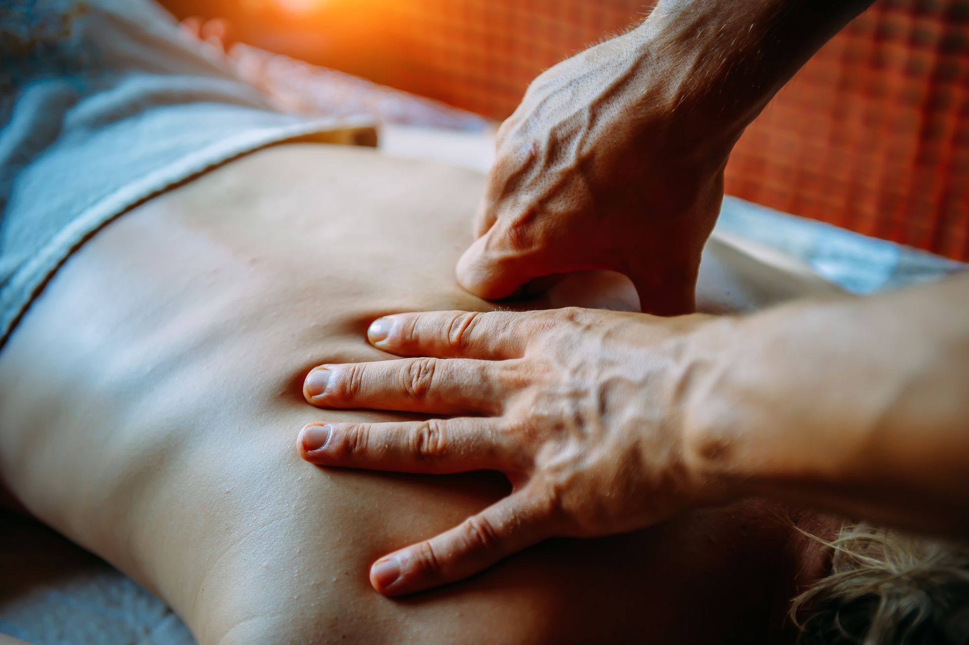 A person is giving a massage to another person.