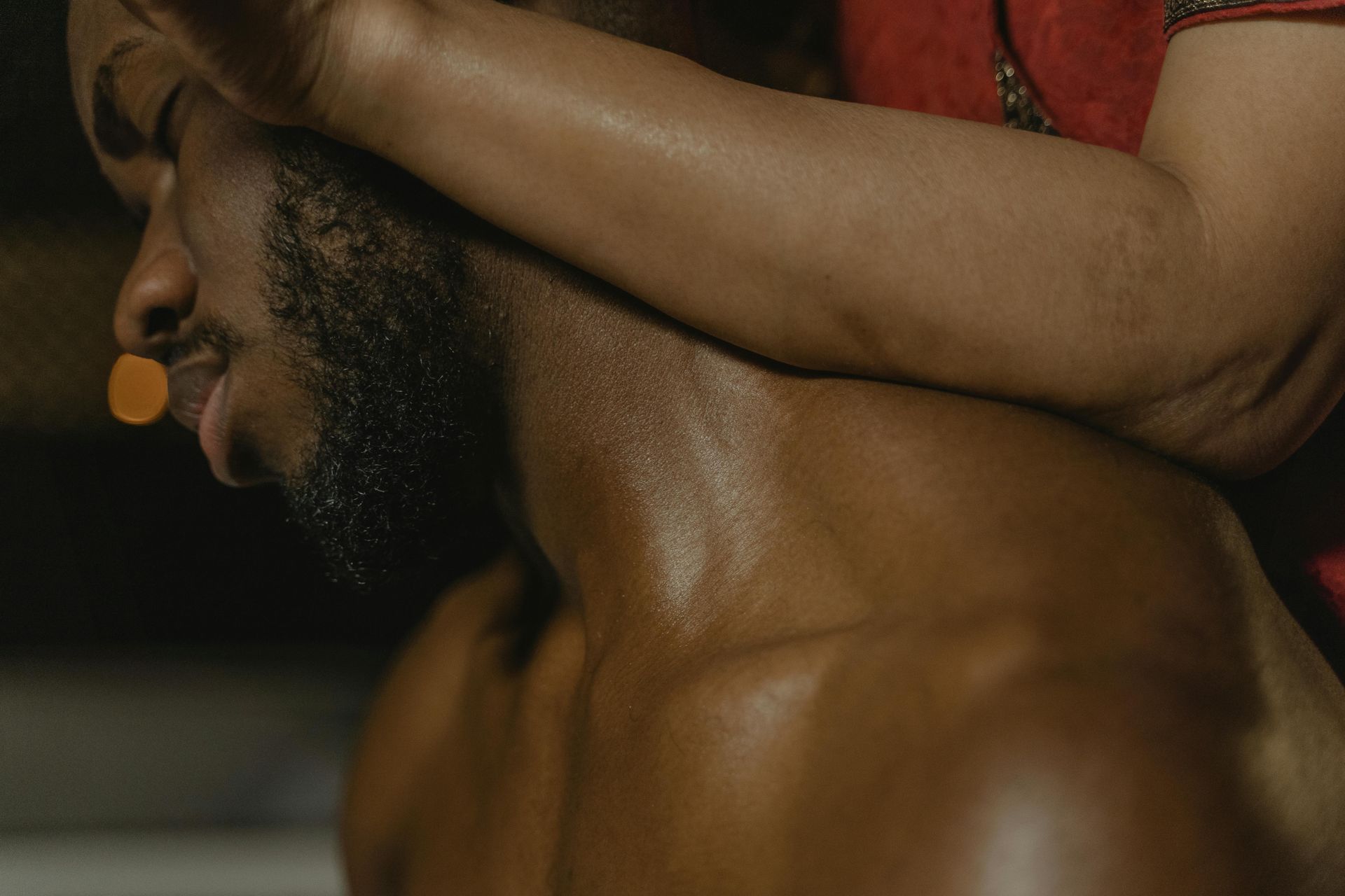 A man is giving a woman a massage on her leg.