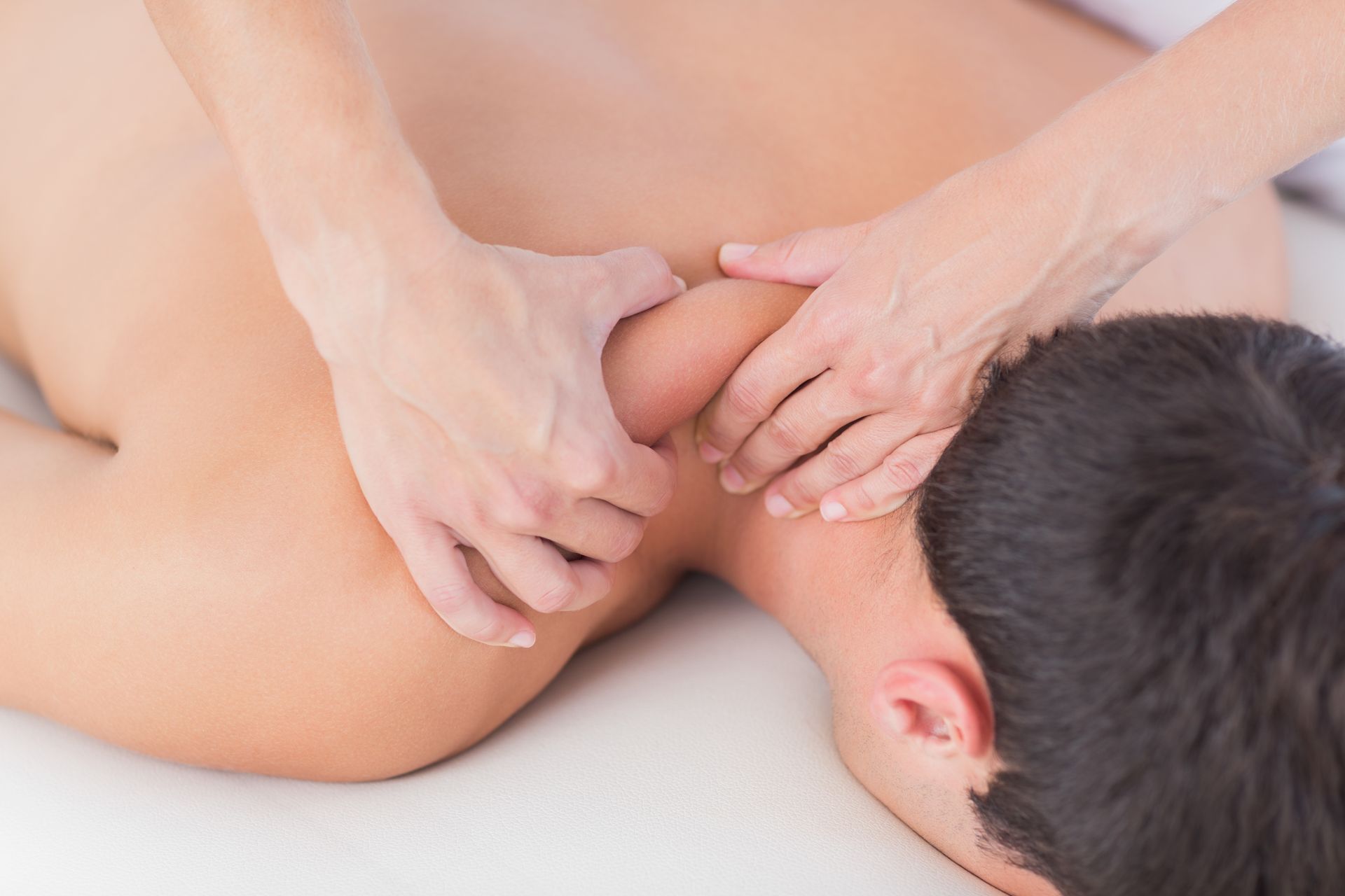 A man is getting a massage on his back at a spa.