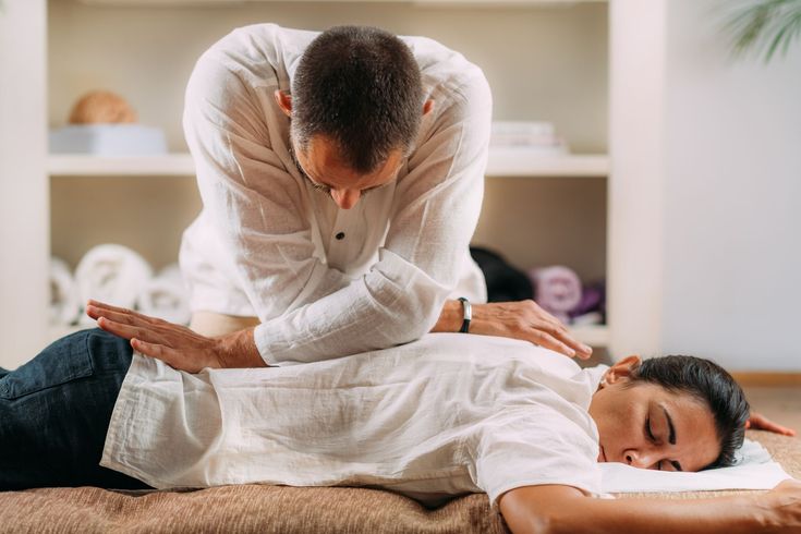 A man is giving a woman a massage in a spa.