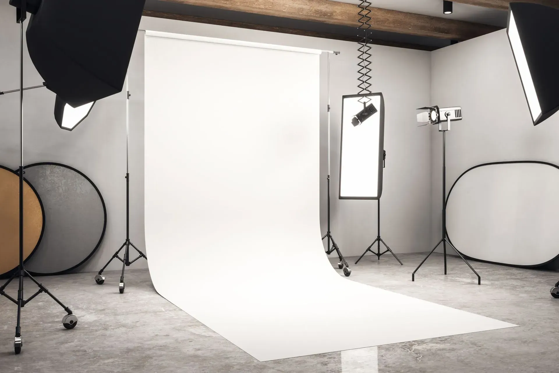 A photo studio with a white backdrop and a lot of lights