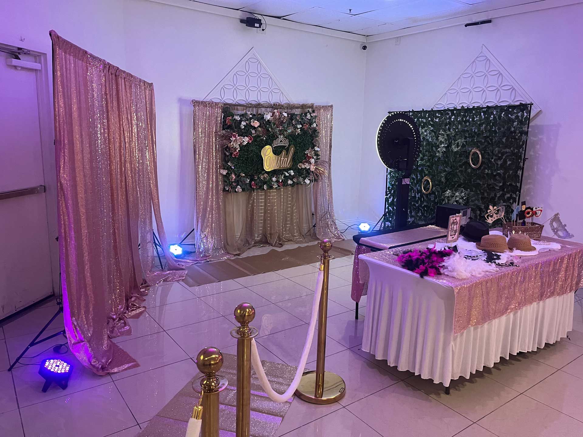 A room decorated for a party with a table and a photo booth.
