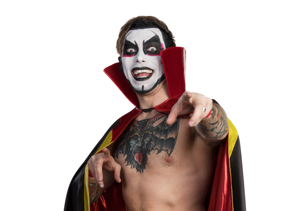 Danhausen in his cape pointing at the camera