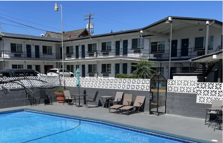 A large building with a swimming pool in front of it