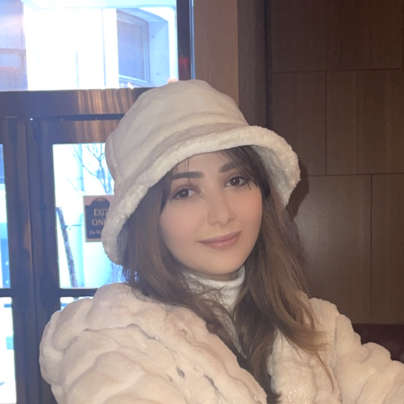 a woman, Merna Alchi, wearing a white hat and a white coat