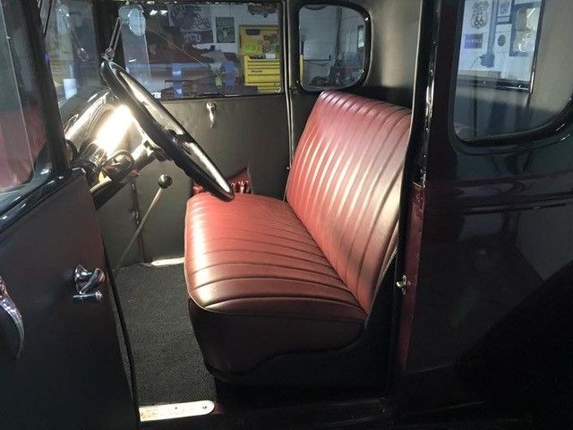 A black car with a red seat and steering wheel
