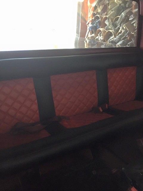 The back seat of a car with a window behind it