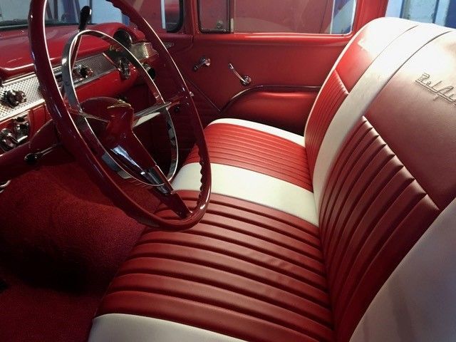 A red and white car with the word bel air on the seat