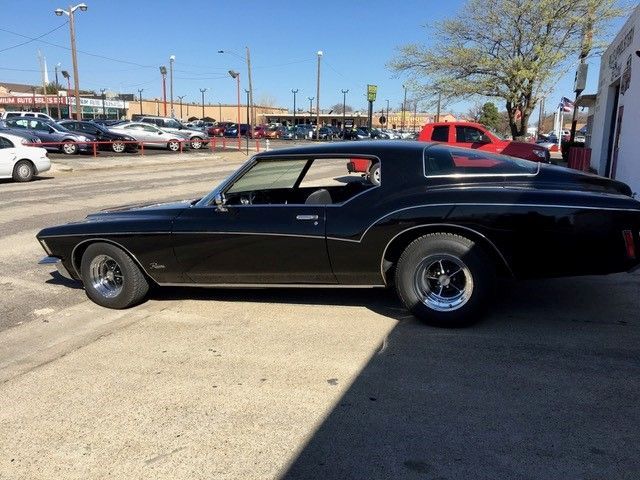 A black car is parked in a parking lot
