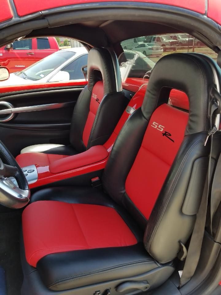 The interior of a car with black leather seats and a steering wheel