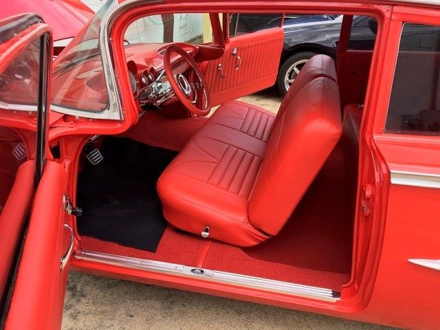 The inside of a red car with the door open