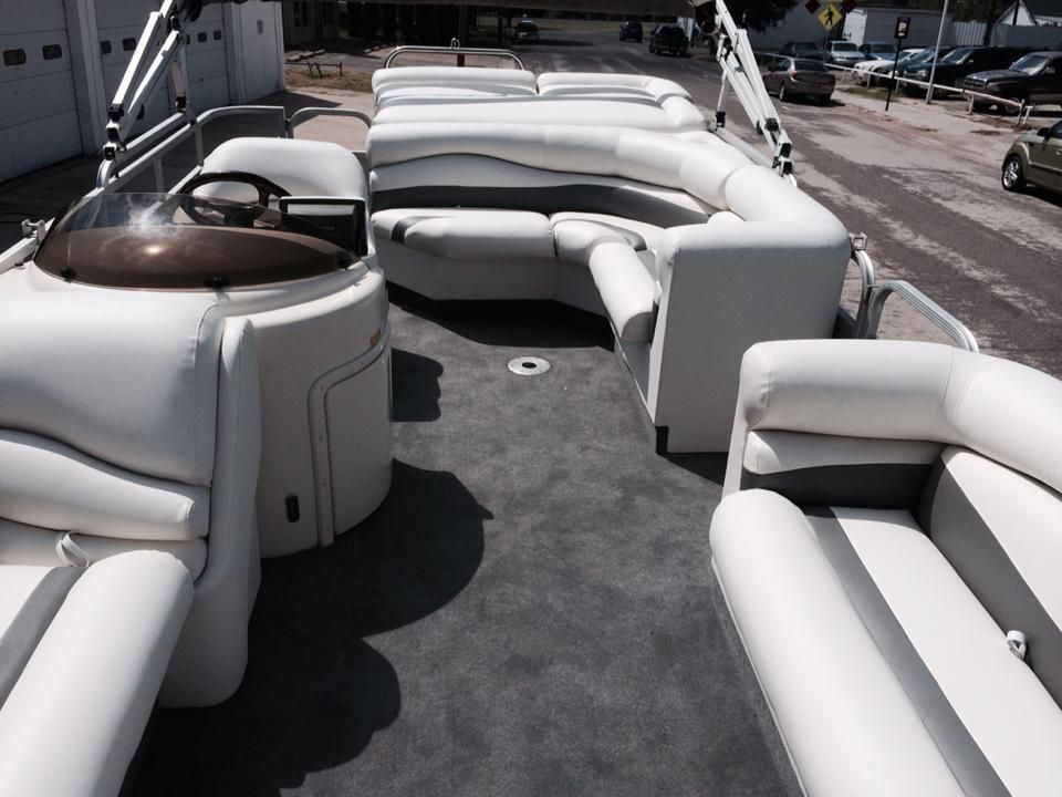 A living room in a camper with a couch and a bed.