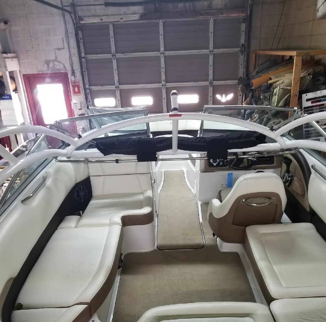 The inside of a boat with a sink and tables