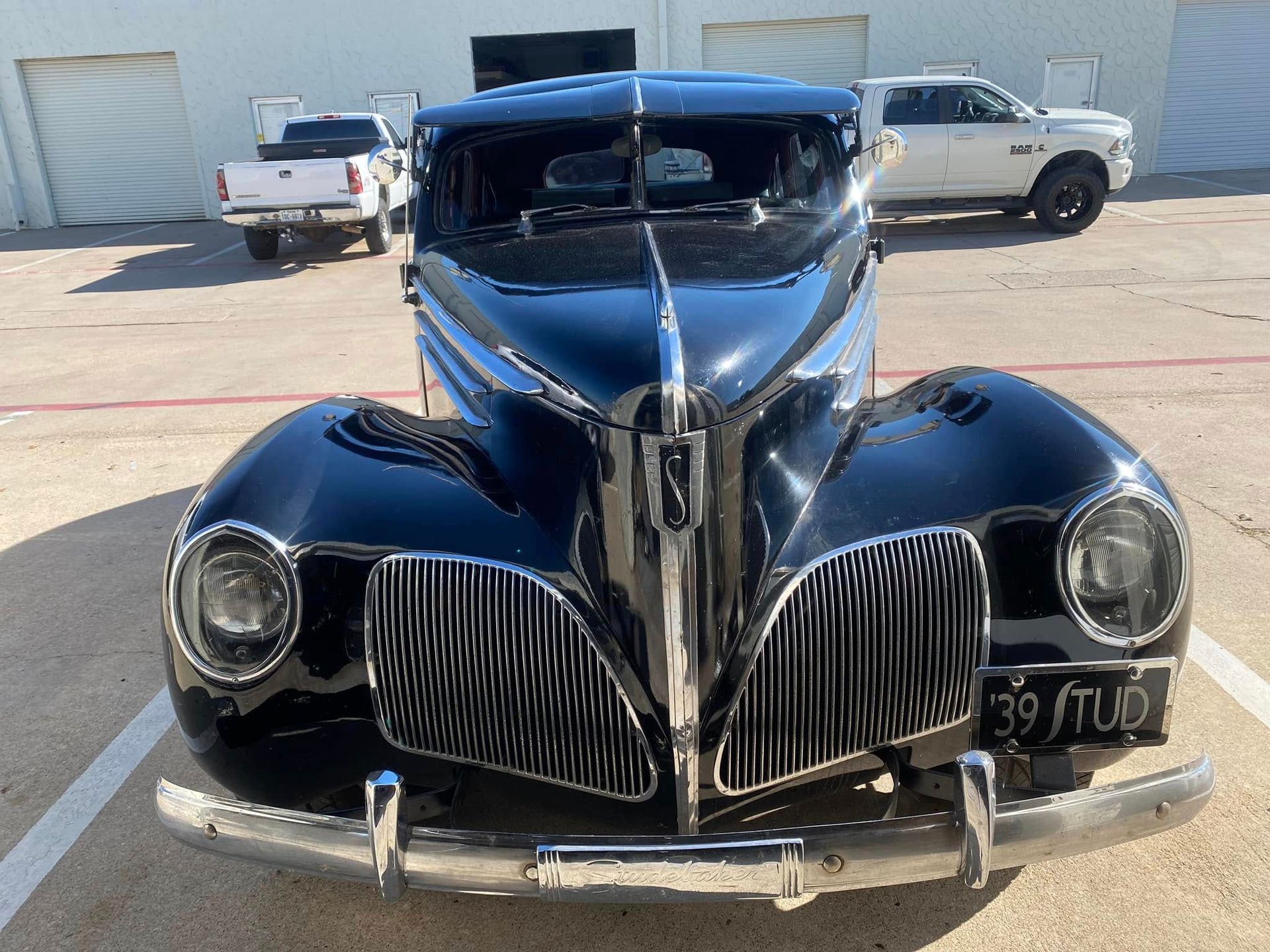 A red and white car is parked in a garage
