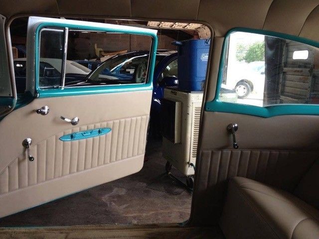 The inside of an old car with the door open