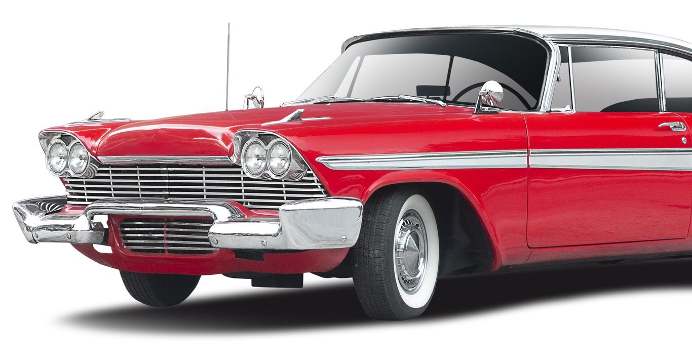 A red car with white tires on a white background