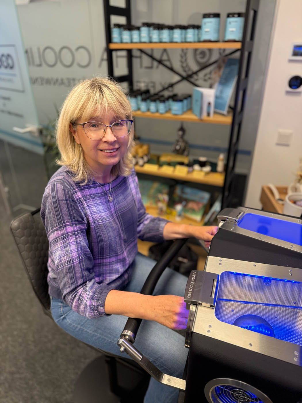 Eine Frau mit Brille und lila Hemd während der Kältetherapie