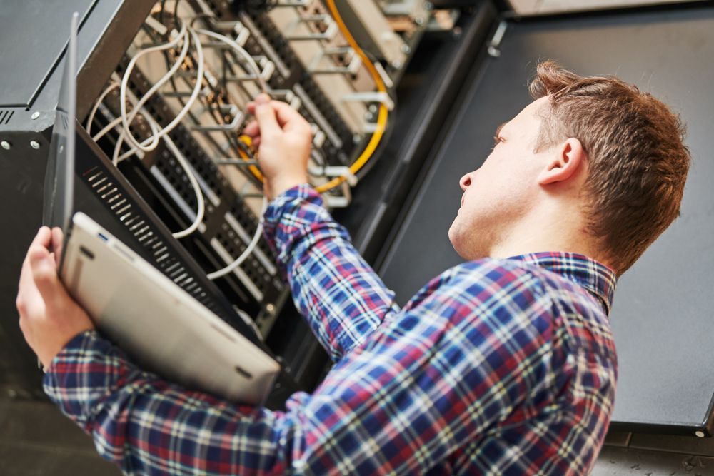 Man Working on Server Equipment in a Data Center — Jendata In Kirwan, QLD