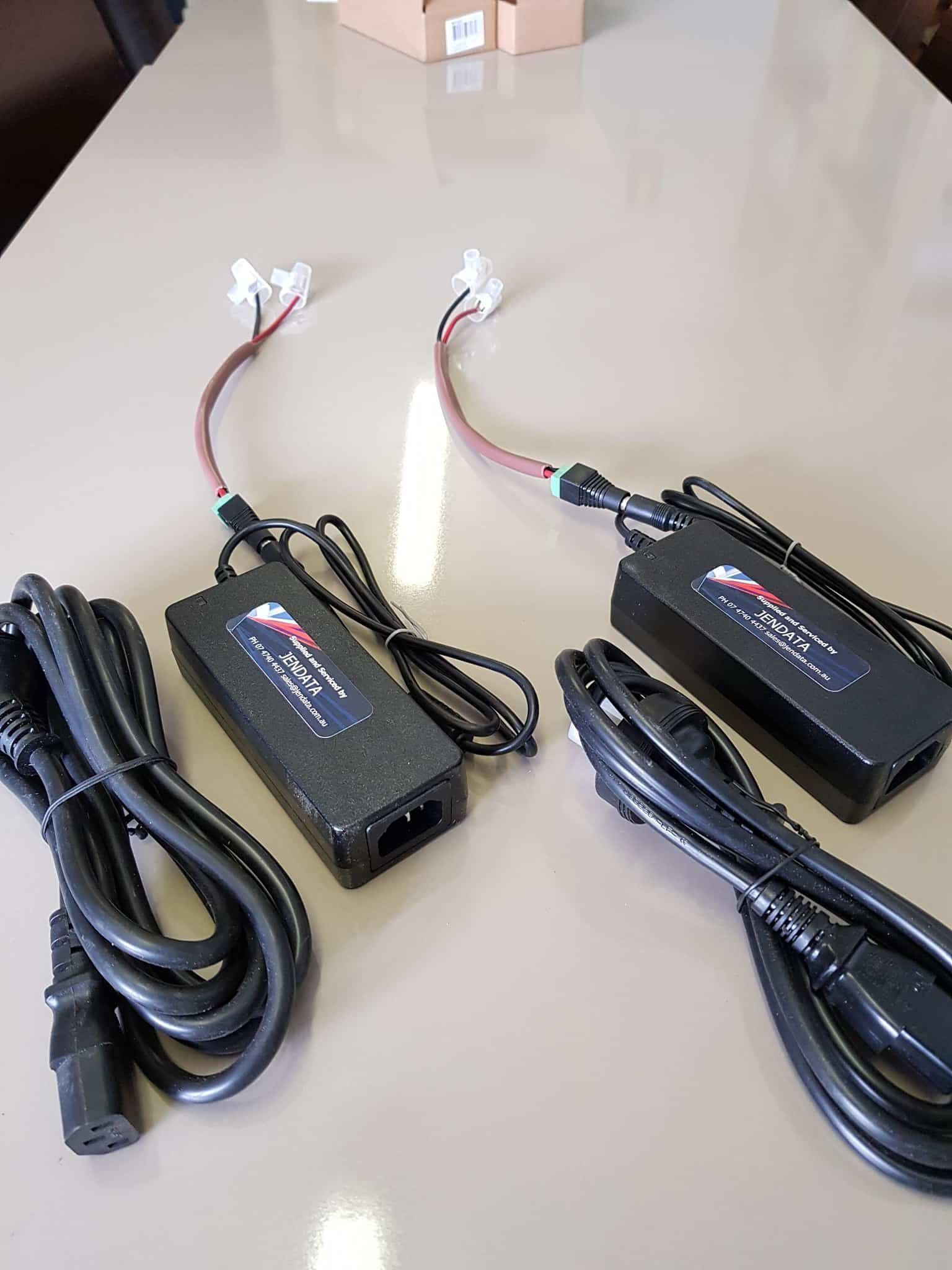 Two Chargers and Cables Are Sitting on a Table — Jendata In Garbutt, QLD