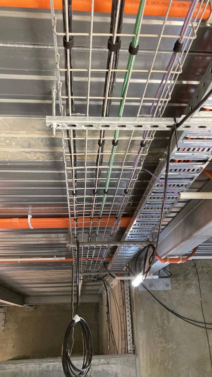 A Bunch of Wires Are Hanging From the Ceiling of a Building — Jendata In Garbutt, QLD