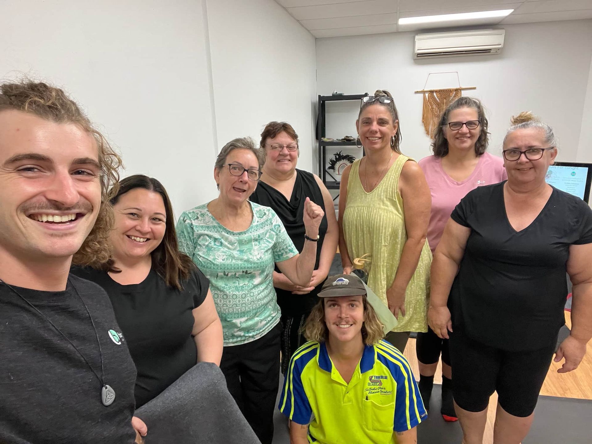 A group of people are posing for a picture in a room.