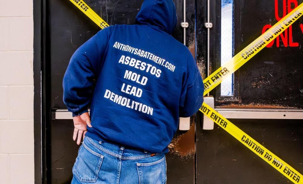 A man wearing a blue hoodie that says demolition