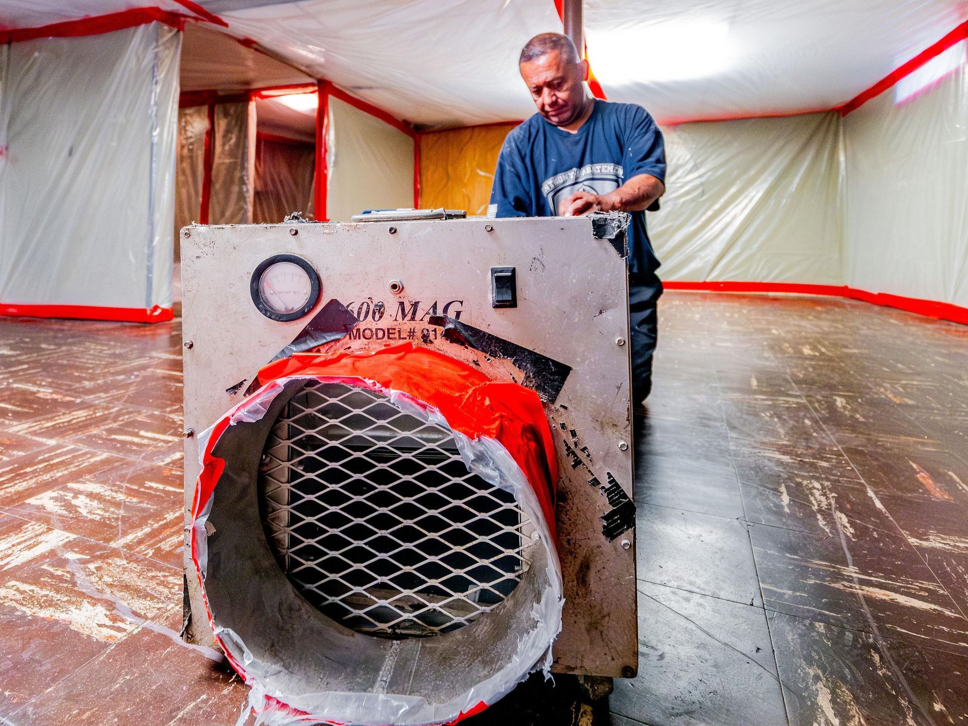 A man is setting up an asbestos air testing machine
