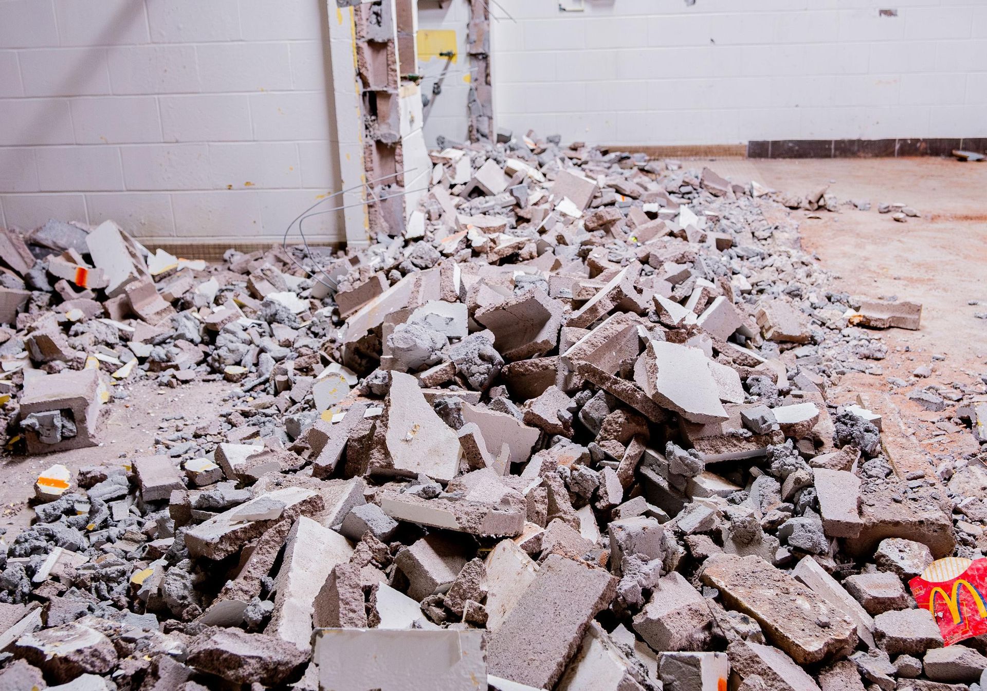 A pile of asbestos cement is sitting on the floor in a room.