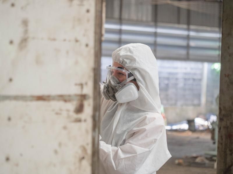 Asbestos worker wearing respiratory protective equipment