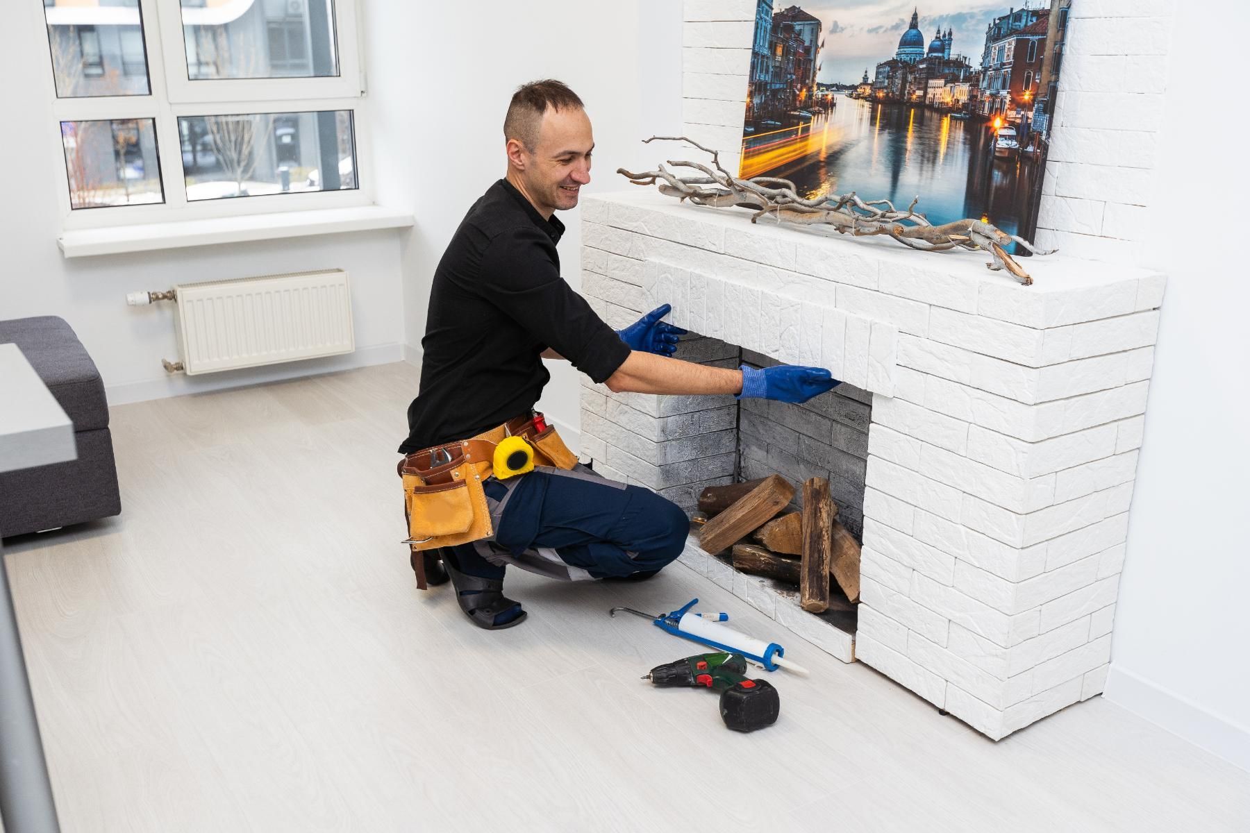 Worker inspecting a modern white brick fireplace for potential asbestos hazards