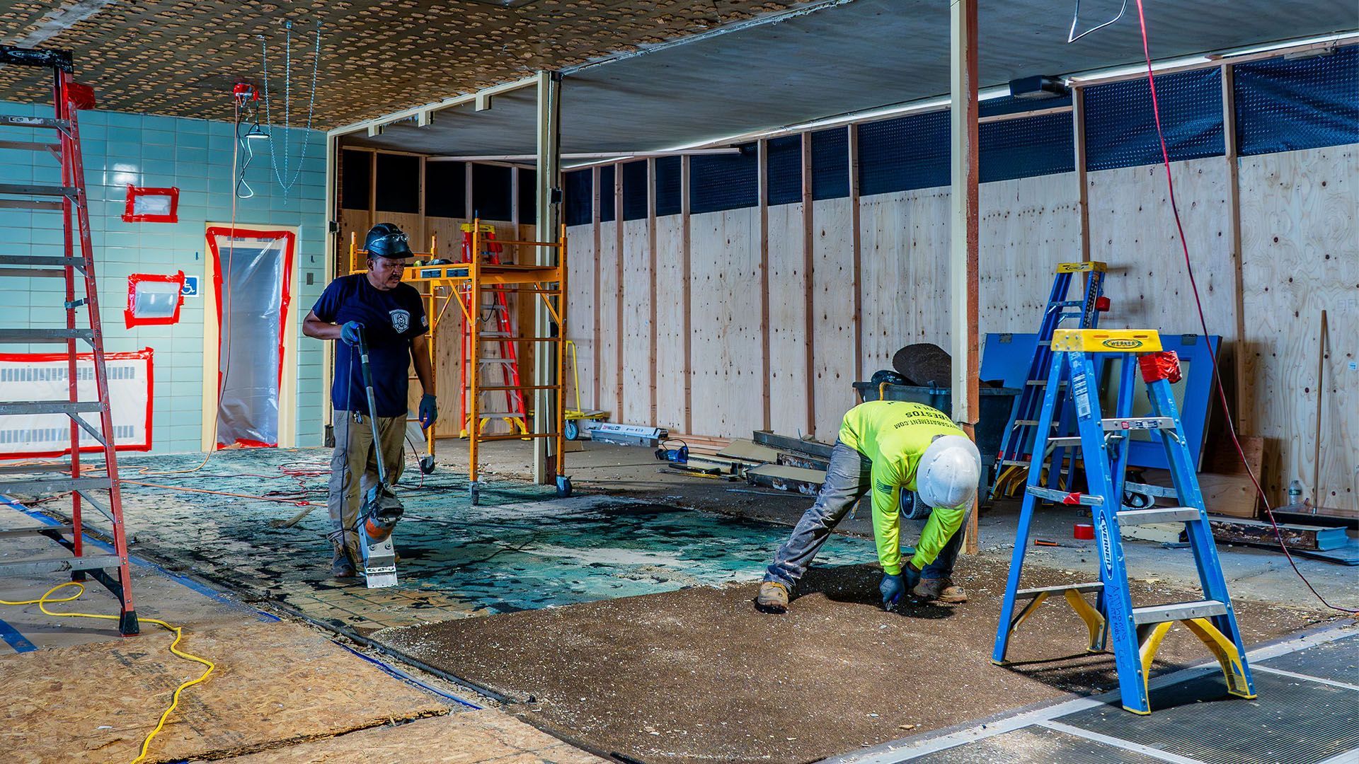 A group of construction workers are working on a building under construction.