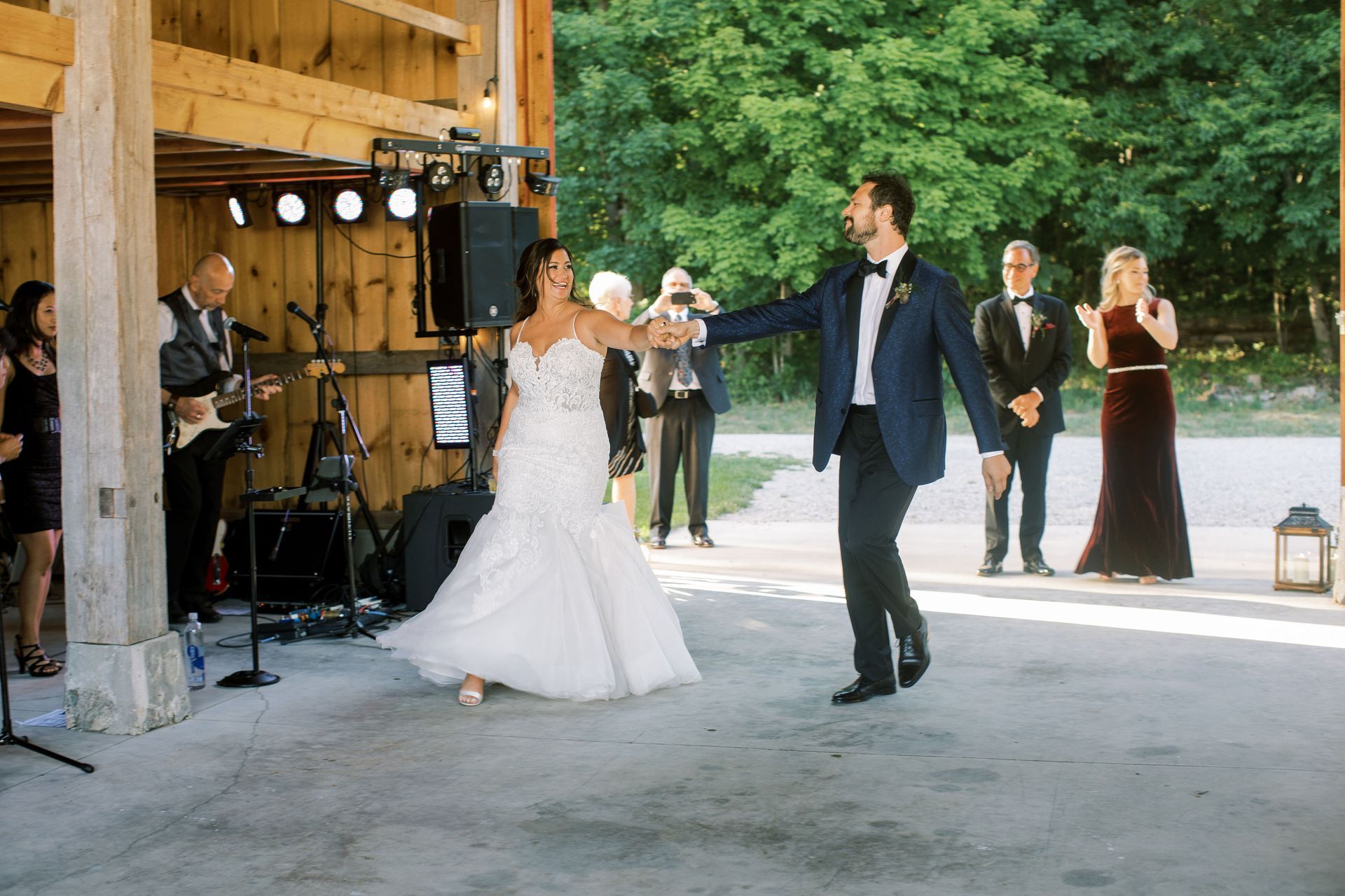 a bride and groom are dancing at their wedding reception in front of a band .