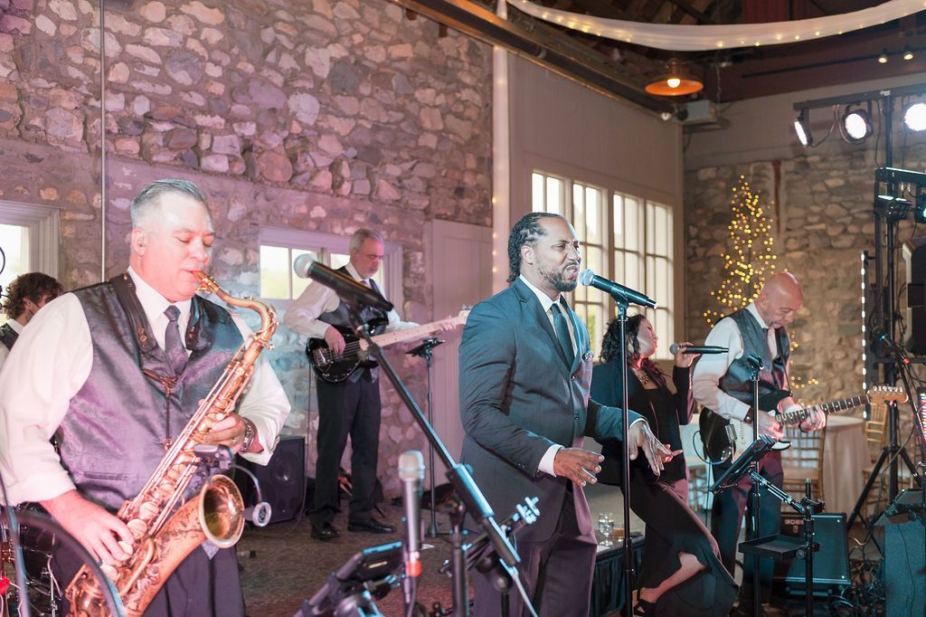 Band leader Jim, with Main Street Soul is playing a saxophone at a wedding reception in Detroit, Michigan