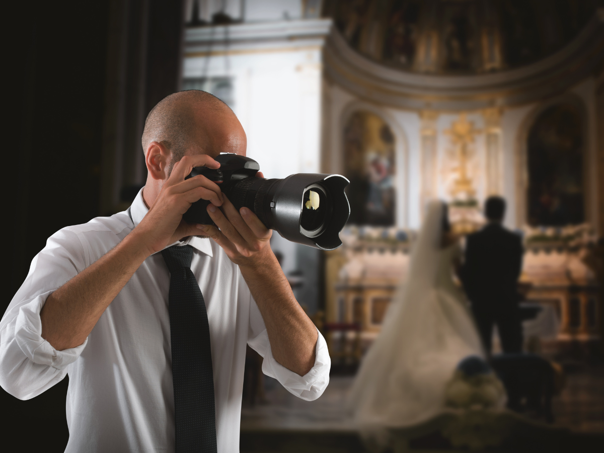 a photographer is taking a picture of a bride and groom in a church