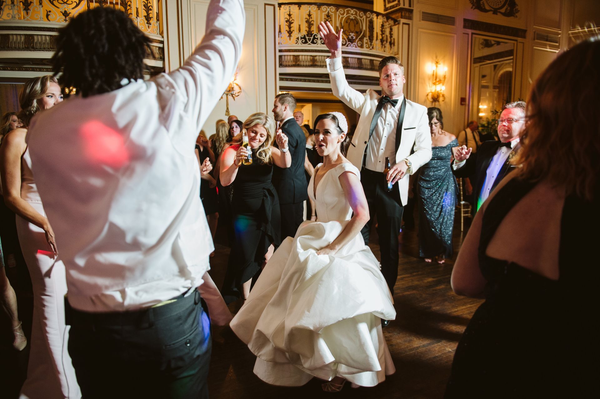 a bride and groom are dancing at a wedding reception with a band member of Mainstreet Soul in Detroit, MI