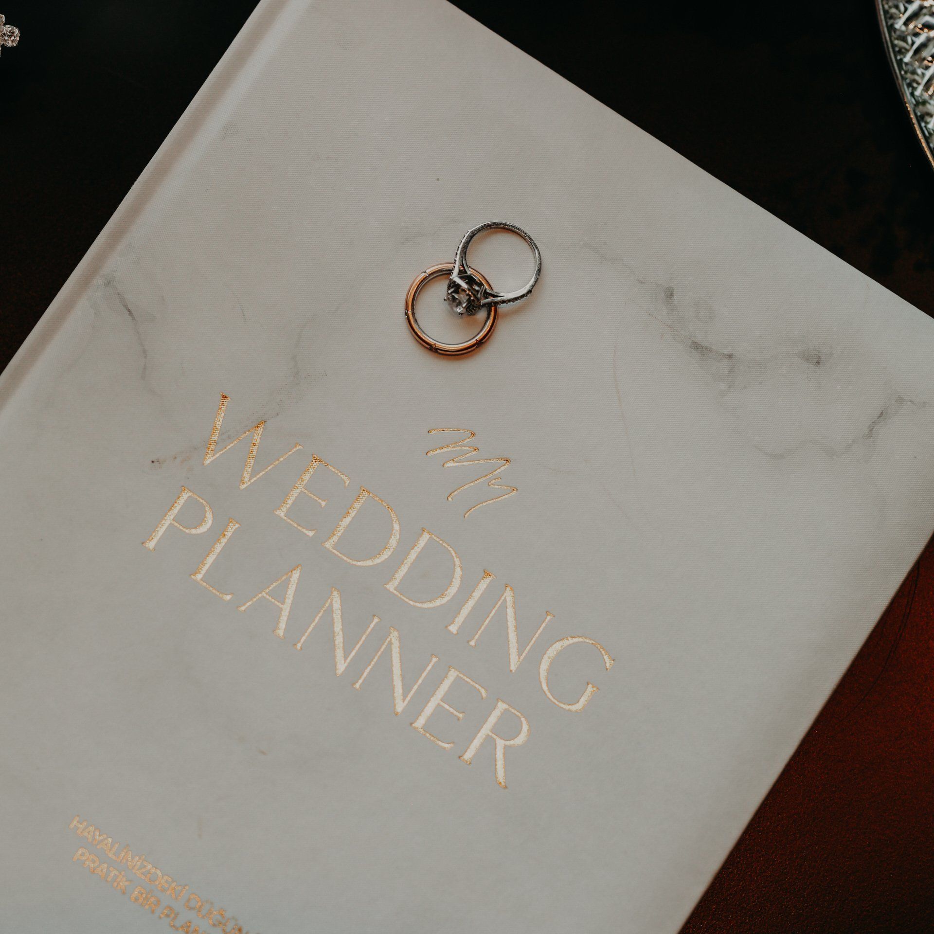 two wedding rings on top of a wedding planner