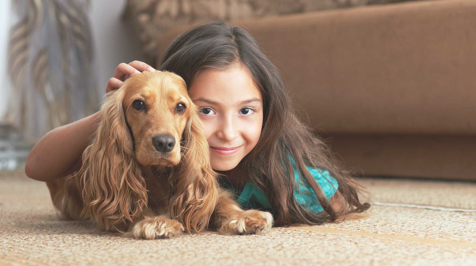 Girl with dog on carpet