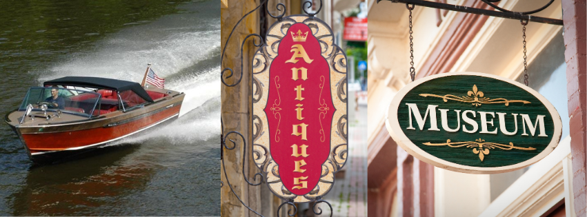 Red boat on water beside a hanging red sign and a green “MUSEUM” sign
