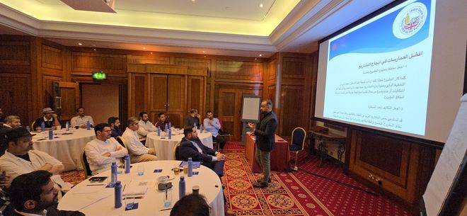 A man is giving a presentation to a group of people in a conference room.