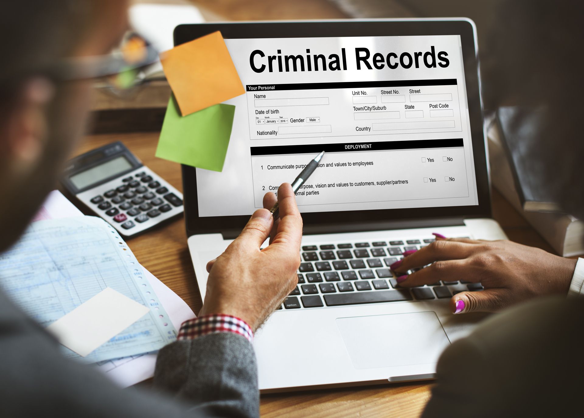 A person is using a laptop computer to look at criminal records.