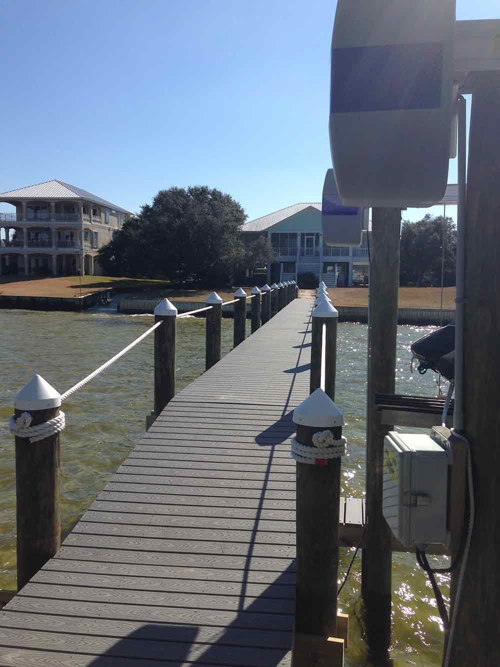 A dock leading to a house on the water