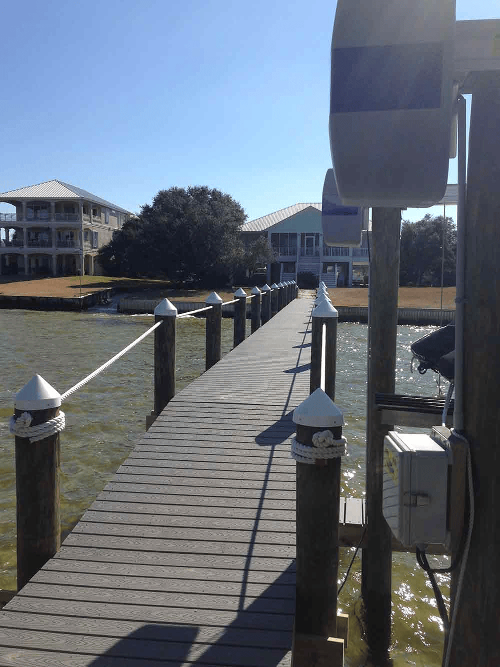 A dock leading to a house on the water