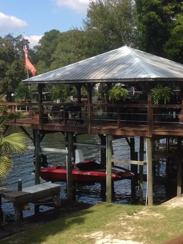 A boat is docked under a gazebo in the water