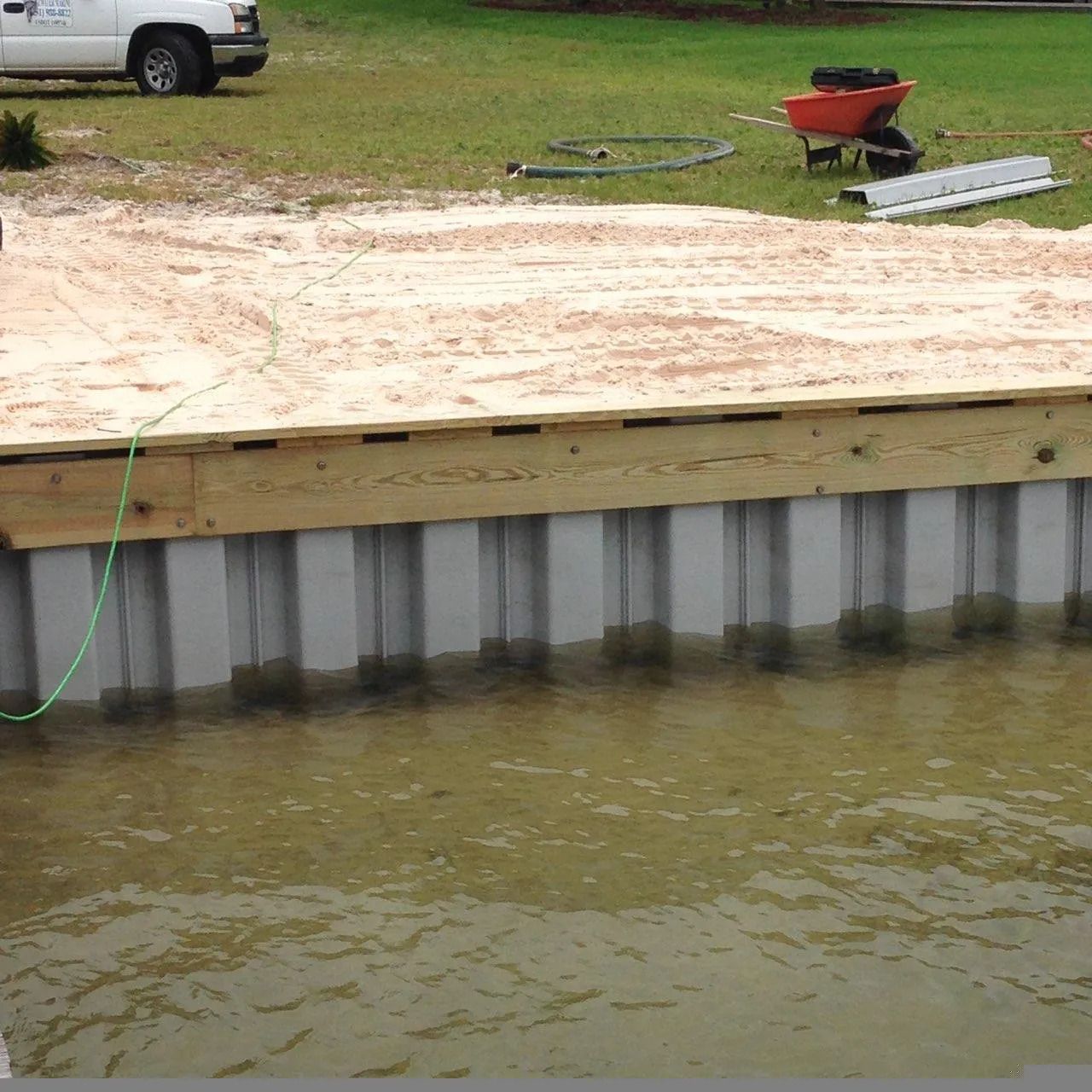 A dock is being built next to a body of water.