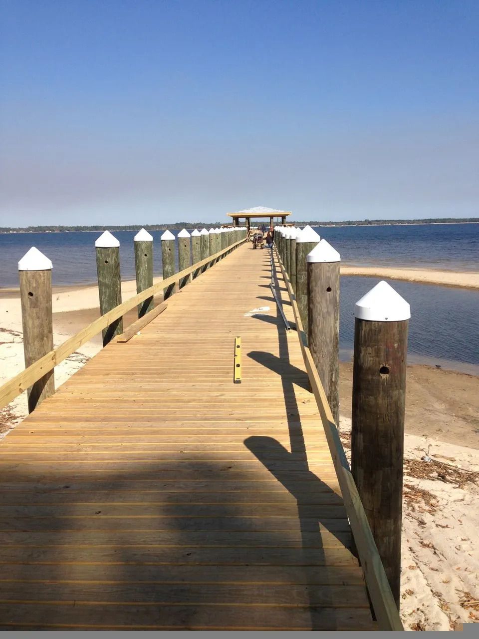 A long wooden dock going into a body of water