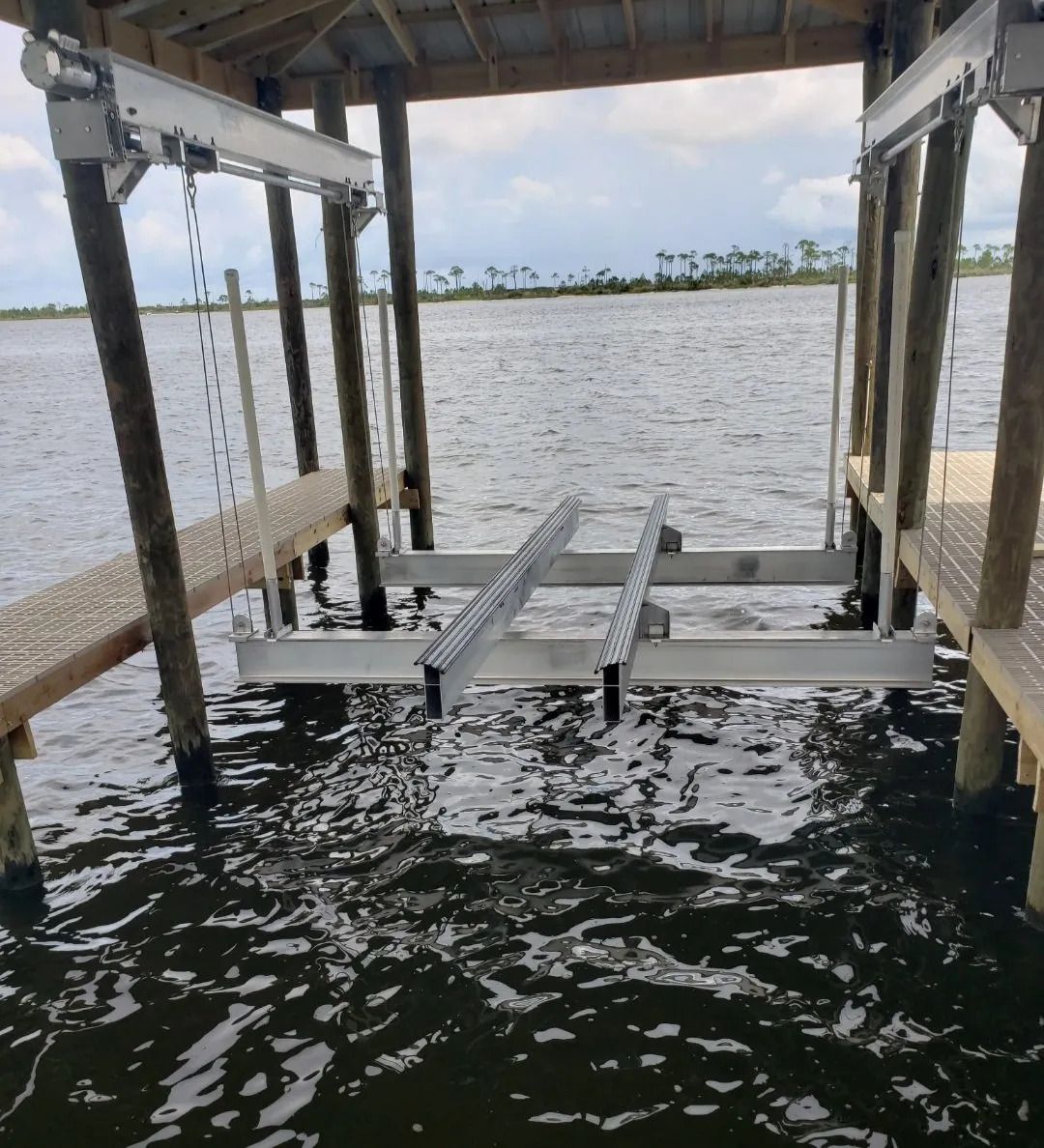 A boat lift is attached to a dock in the water