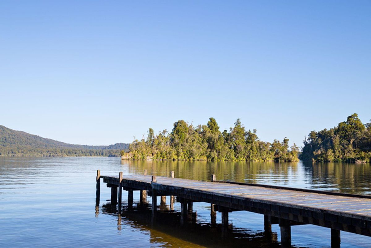 There is a dock in the middle of a lake.