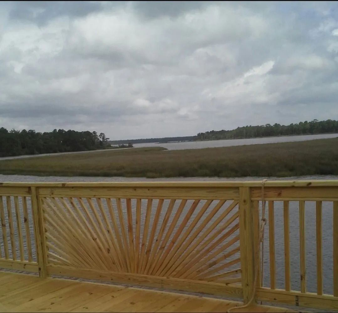 A wooden deck overlooking a body of water