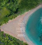 An aerial view of a beach surrounded by trees and water