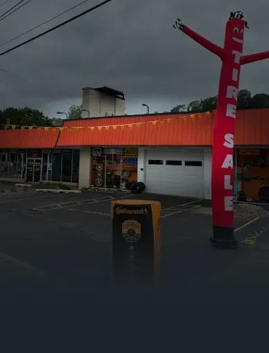 Outside of our shop with Tire Sale Inflatable man | After Hours Tires